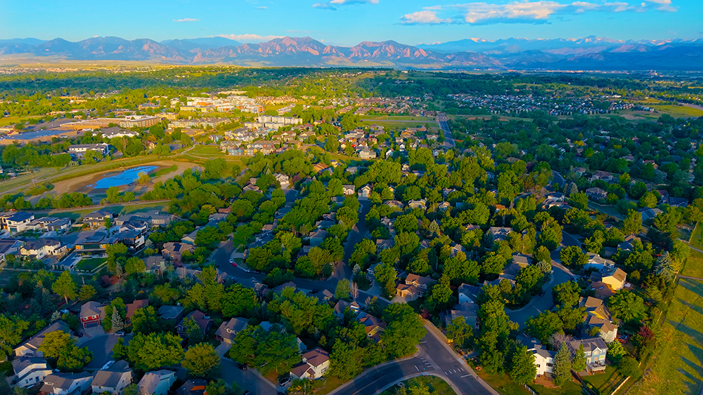 Aerial drone photo of the Waneka Landing neighborhood in Lafayette, Colorado, near Waneka Lake with views to the Flatirons.