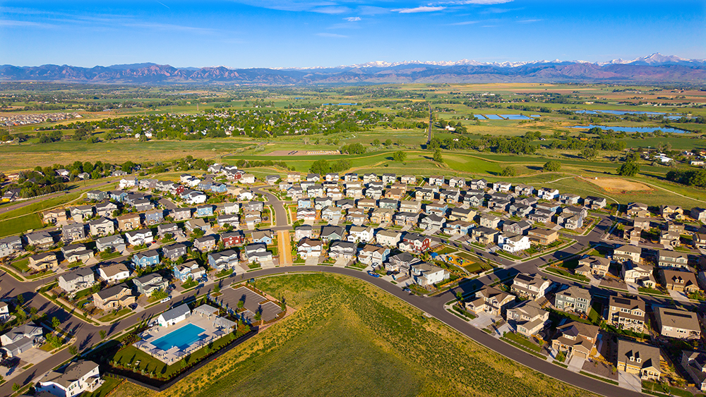 Aerial drone photo of the Morgan Hill neighborhood in Erie, Colorado, with looping trails and open Front Range views.