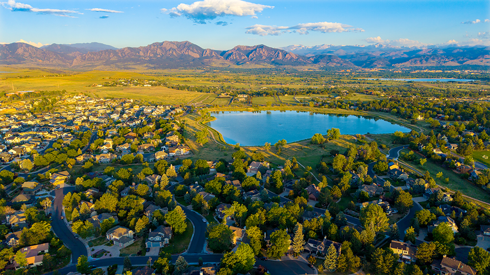 Aerial drone photo of the Hillside neighborhood in Louisville, Colorado, with tree-lined streets near historic downtown.