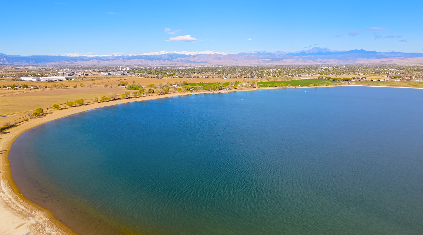 Aerial drone photo of Union Reservoir in northeast Longmont, Colorado, a 736-acre park with open water and Front Range views.