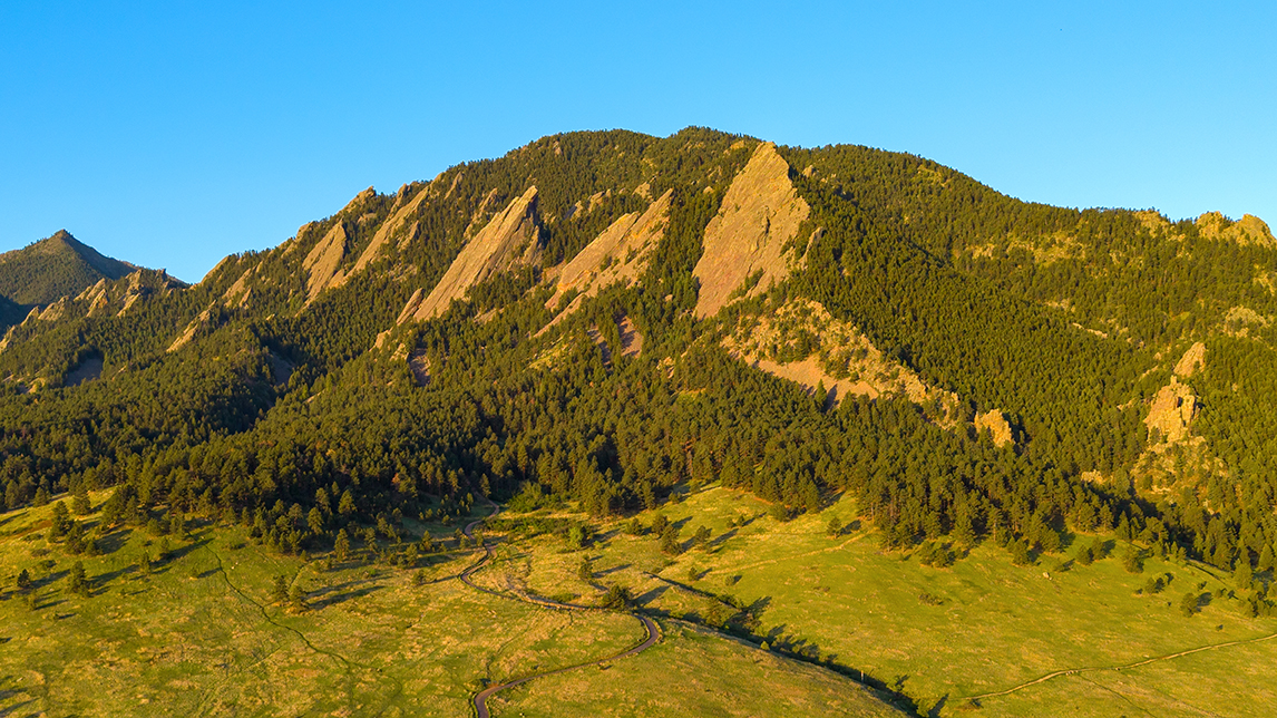 Aerial drone photo of Boulder, Colorado, anchored by the University of Colorado and the iconic Flatirons.