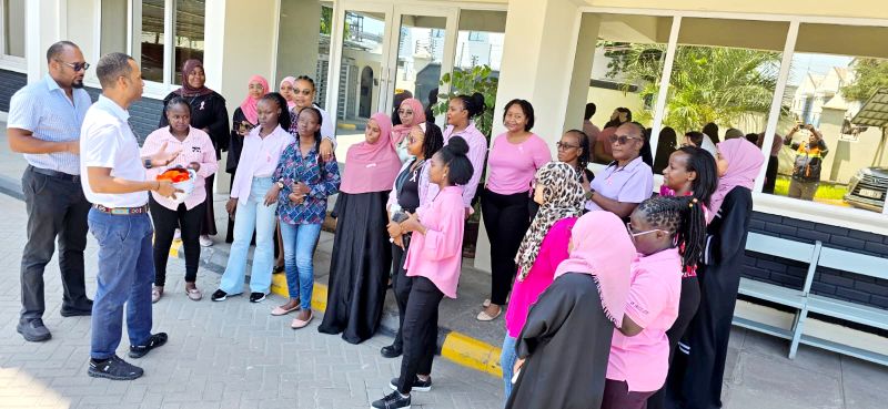 Pink Thursday group photo at the office entrance