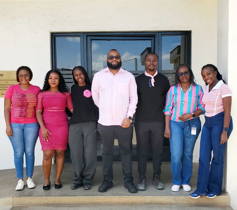 Colleagues in pink outside the office entrance on Pink Thursday