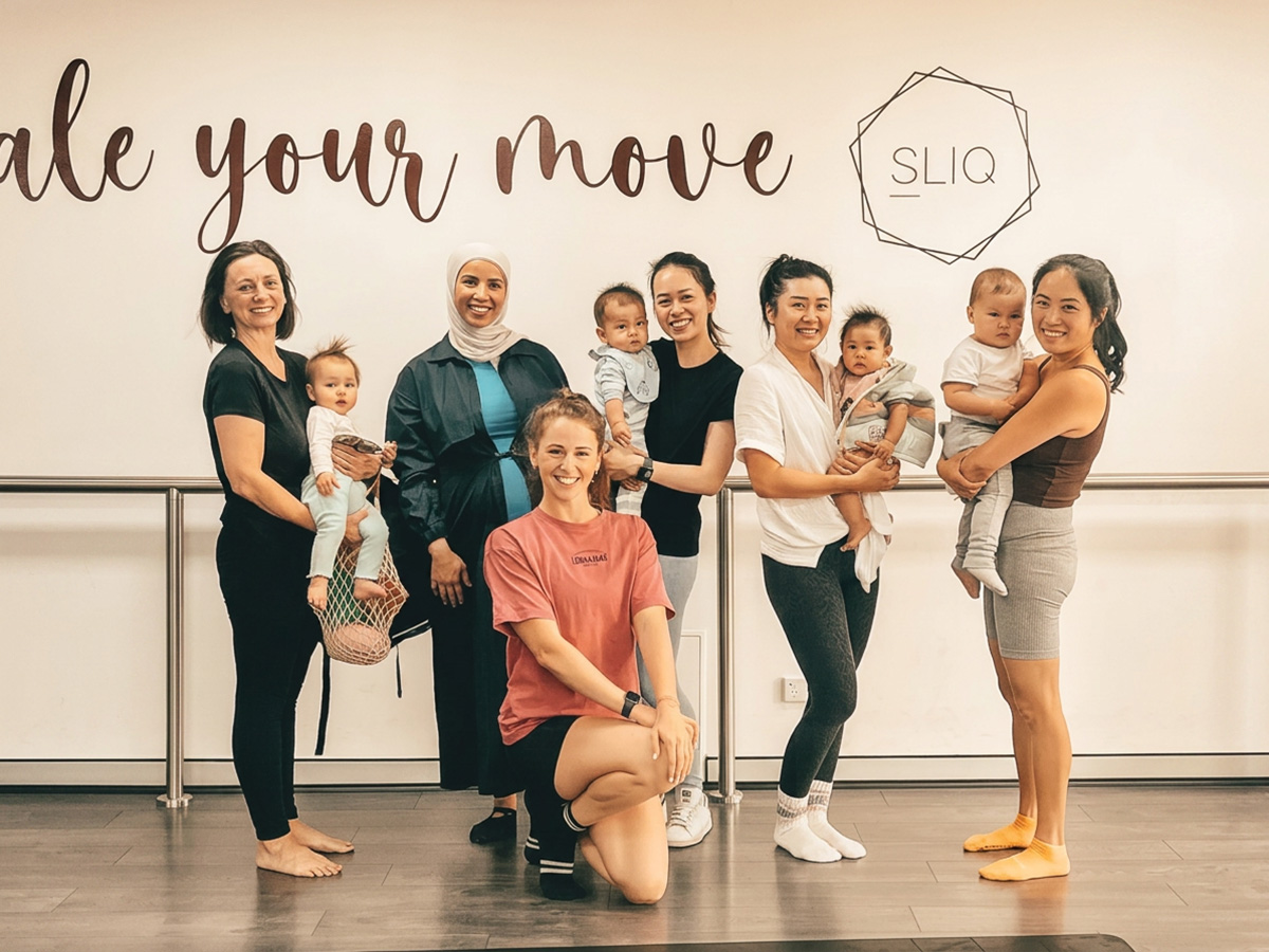 Mothers holding their babies after a mums and bubs fitness class at SLIQ