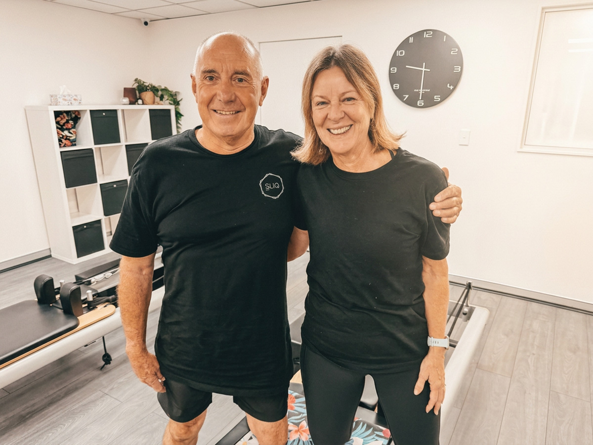 Smiling older couple at a Pilates studio after their exercise session