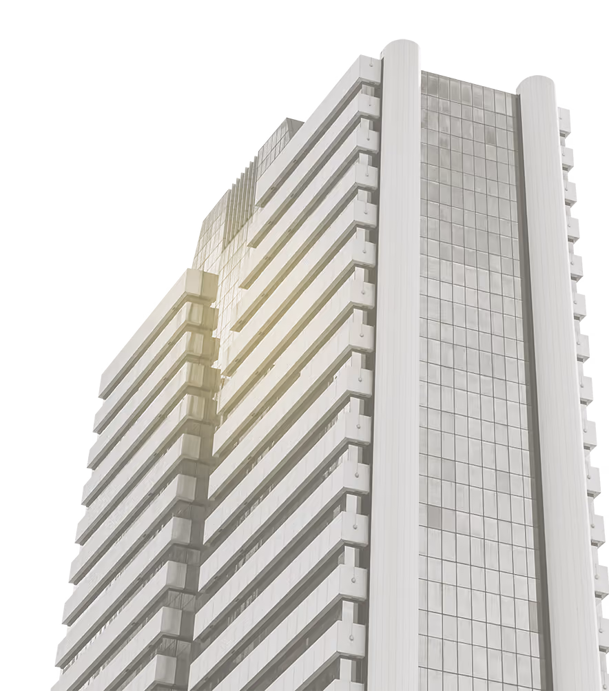 Close-up of a modern high-rise building with glass windows and horizontal balcony lines in sunlight.