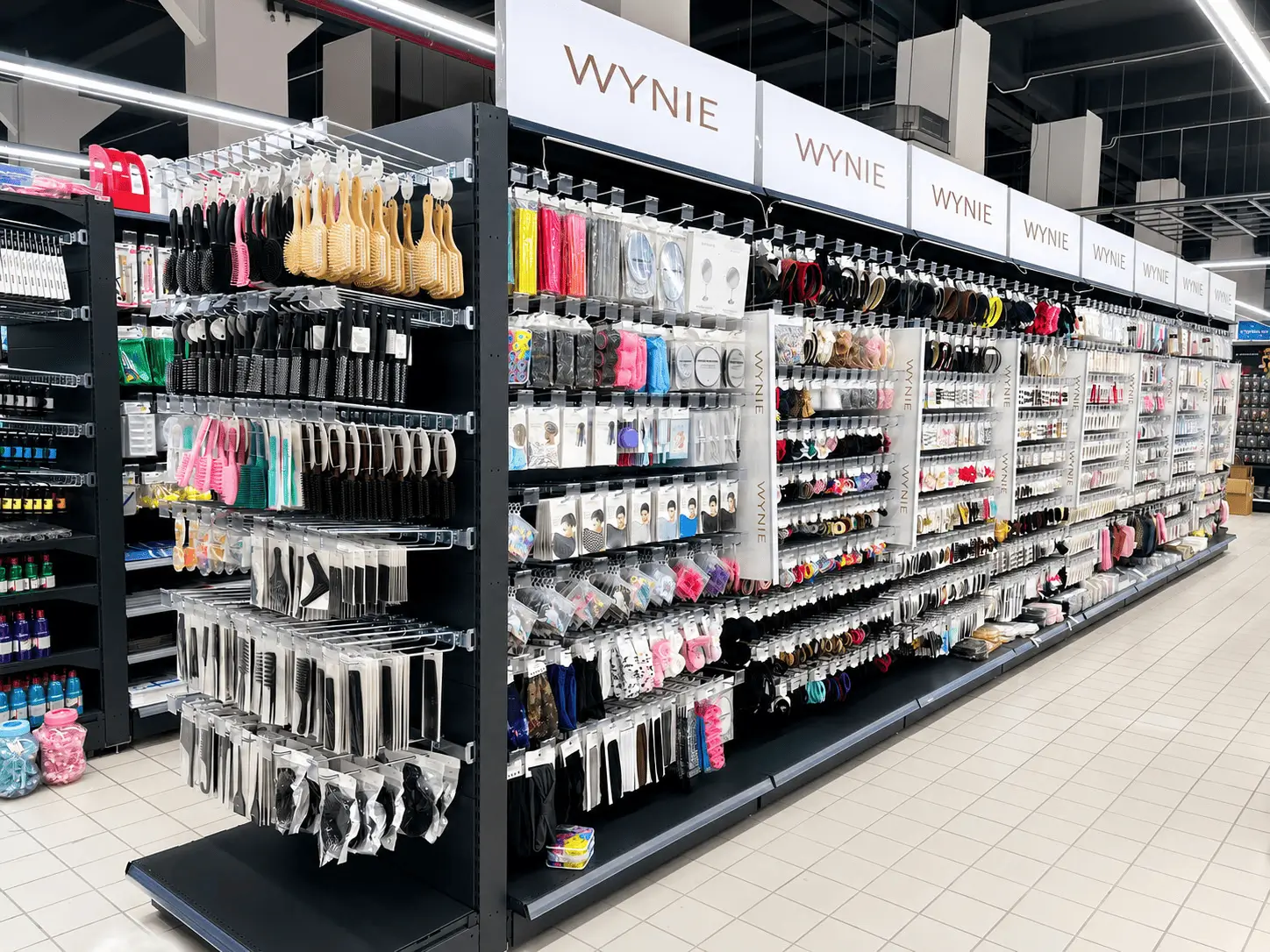 Store display with various hairbrushes, combs, hair accessories, and beauty items on shelves.