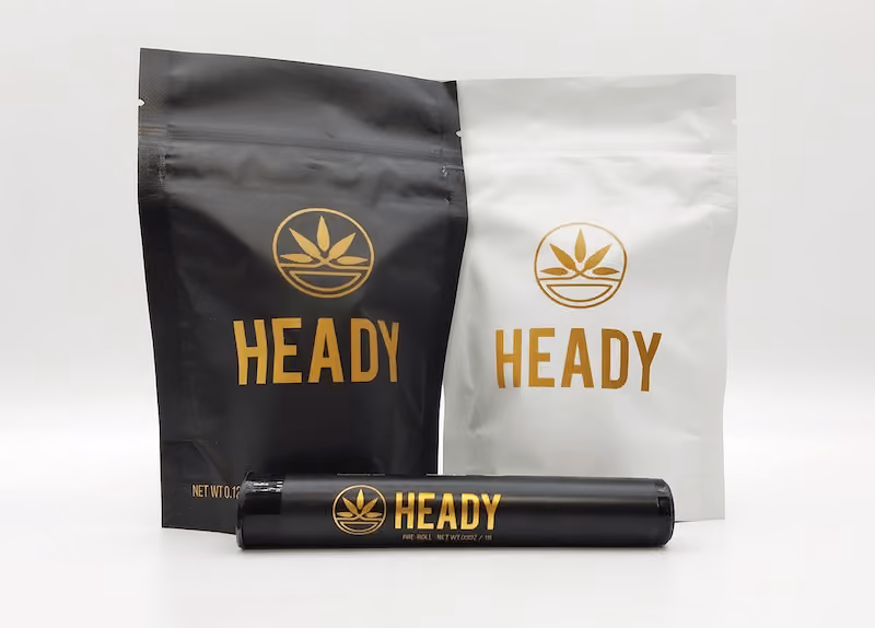 Black and white Heady branded bags and a black Heady tube with gold logos and text.