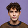 Young man with curly brown hair wearing a dark sweater, facing forward with a neutral expression.