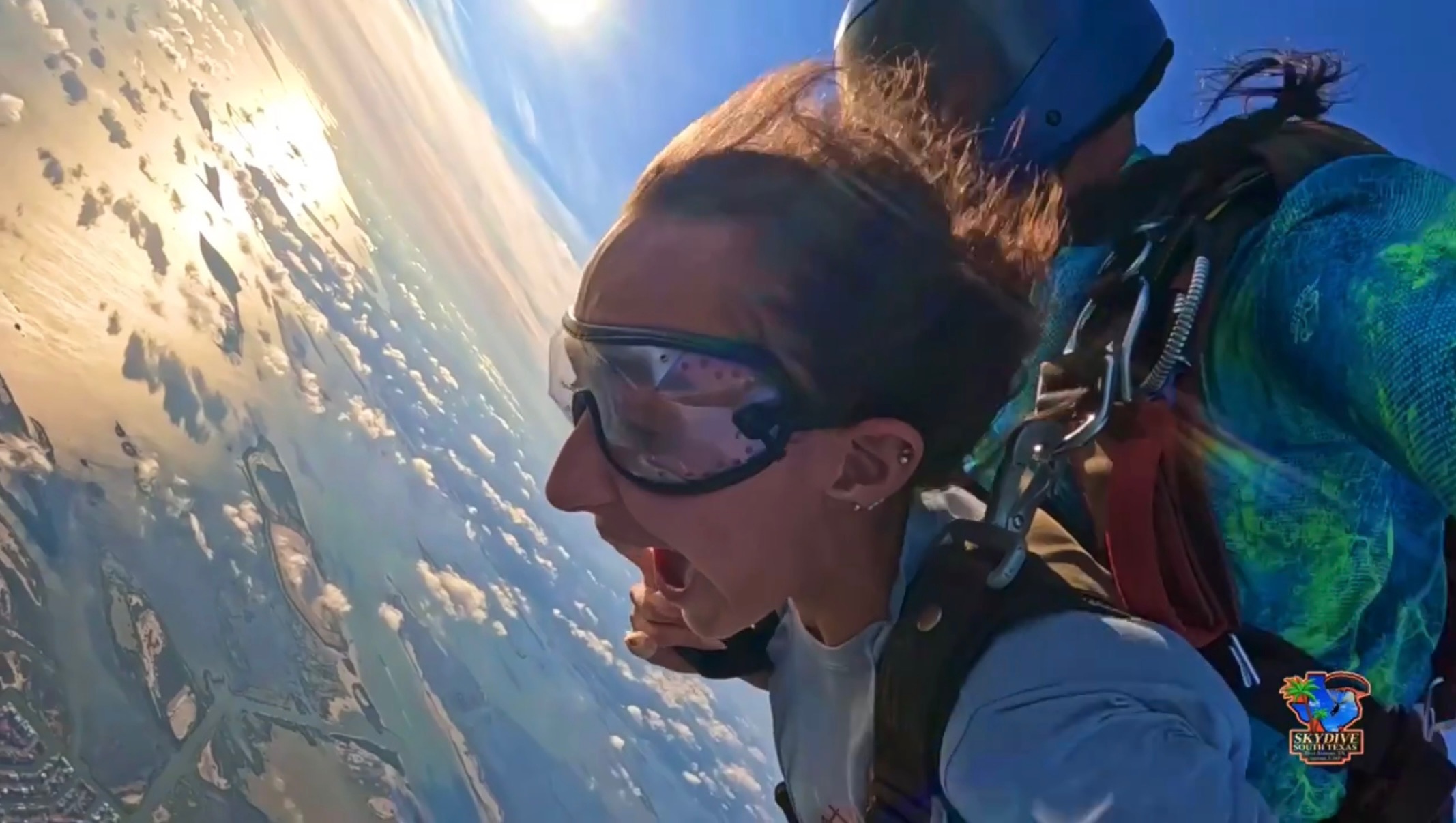 Tandem skydivers in freefall over the Texas Gulf Coast