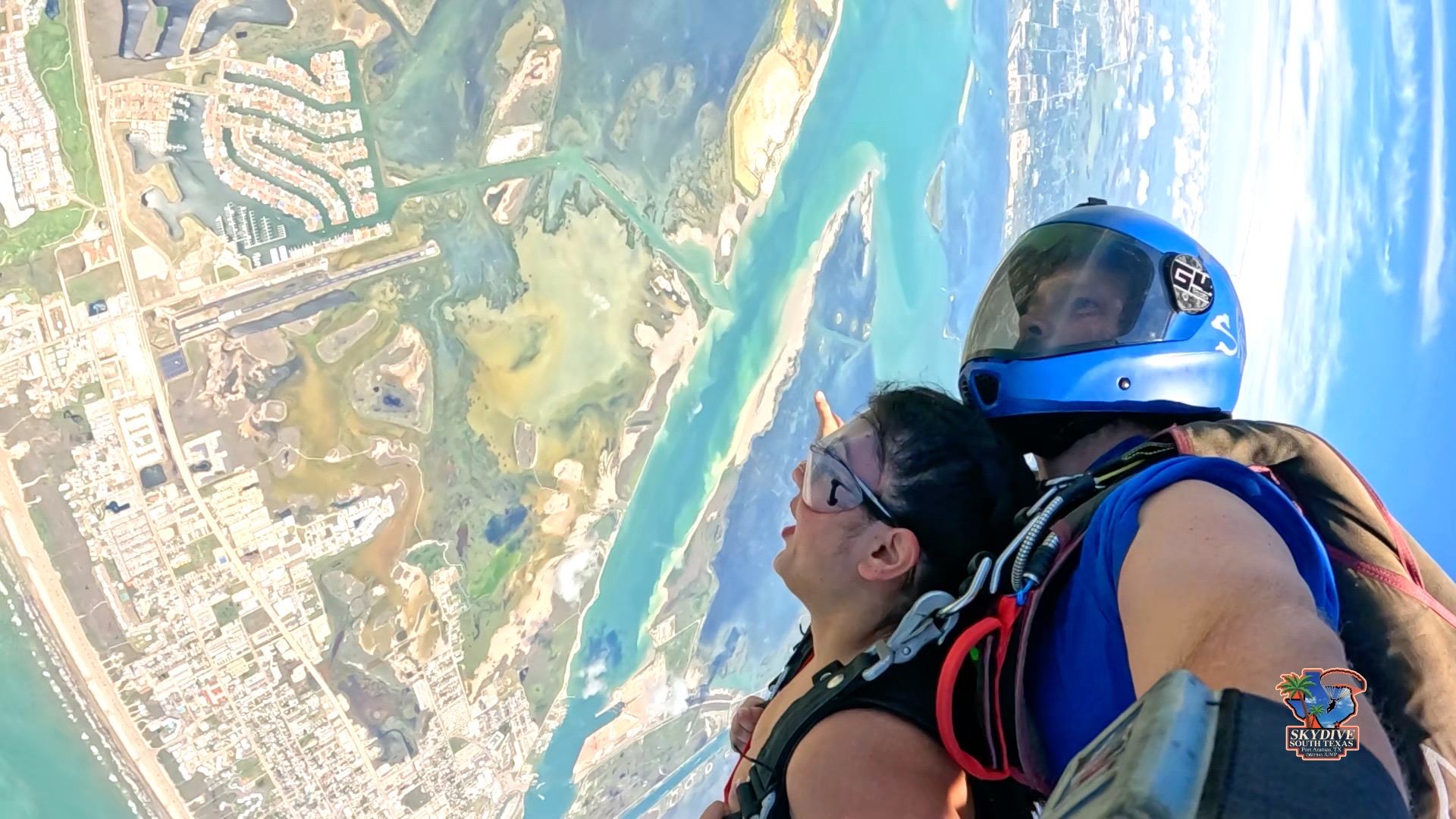 Tandem skydivers over the Mustang Island coastline