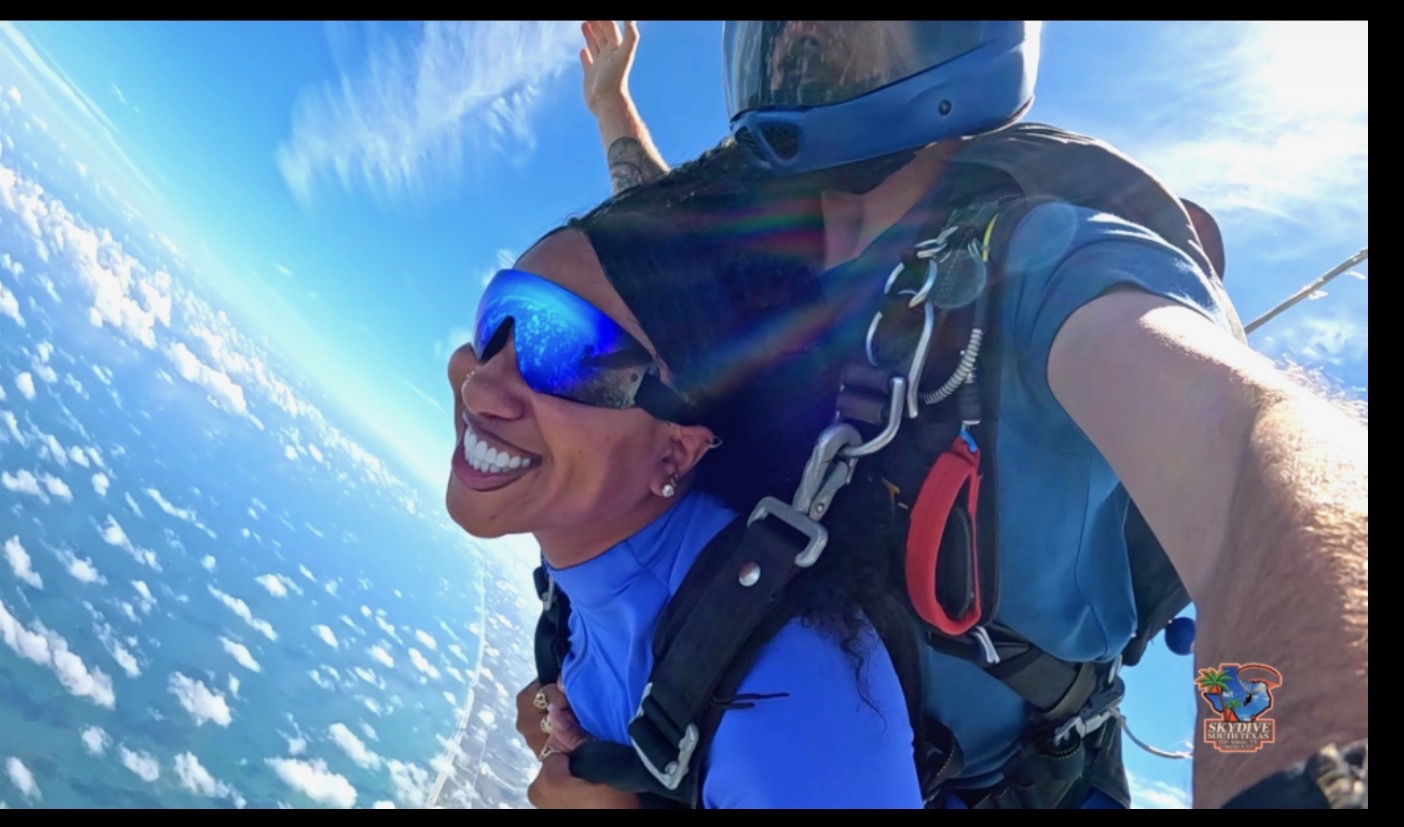 Tandem skydiver smiling on the way down