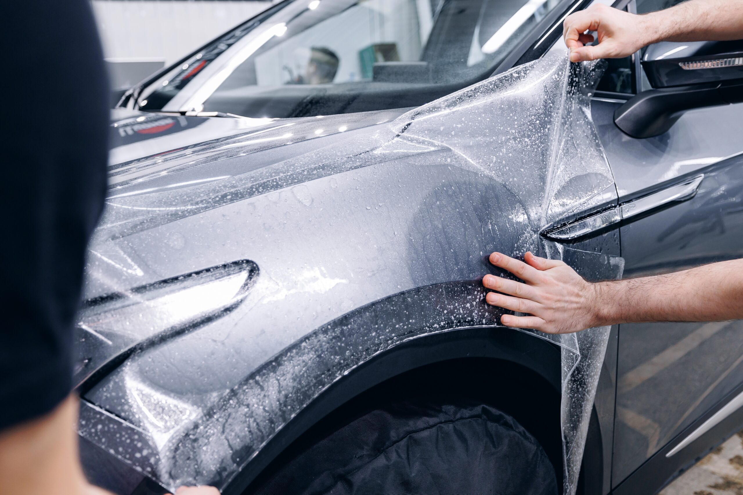 image of a car enthusiast examining a vehicle