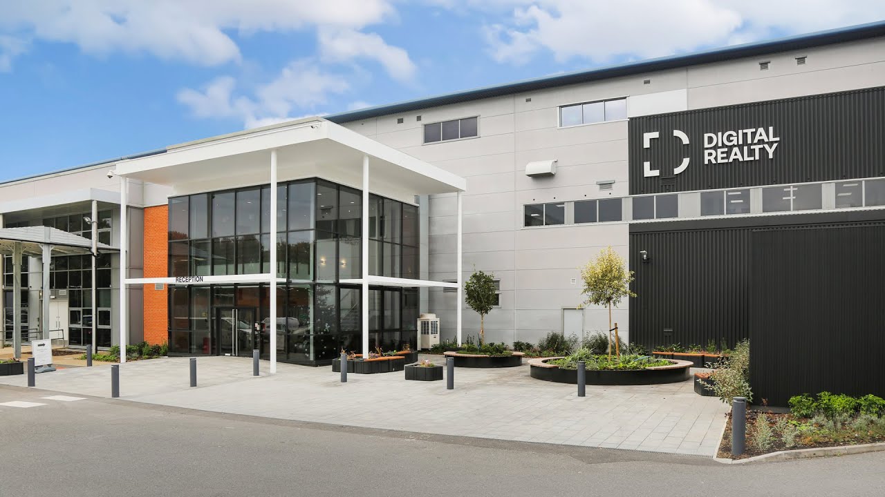 Modern building with glass entrance labeled 'Reception' and Digital Realty logo on the facade.