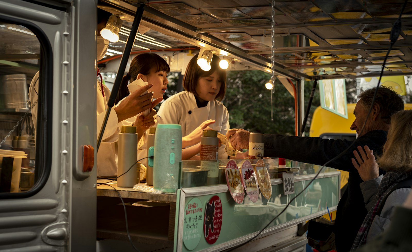 A group of people gathered around a food truck at an outdoor event