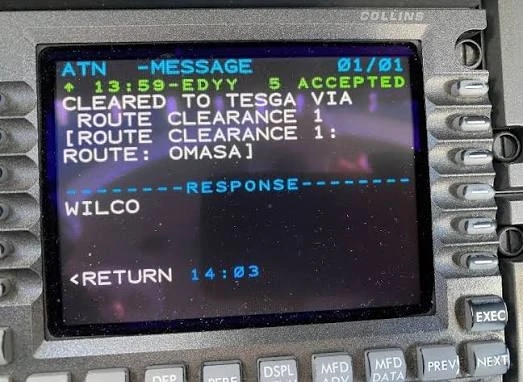 A Collins ATN CPDLC cockpit display showing an accepted route clearance message with a WILCO response