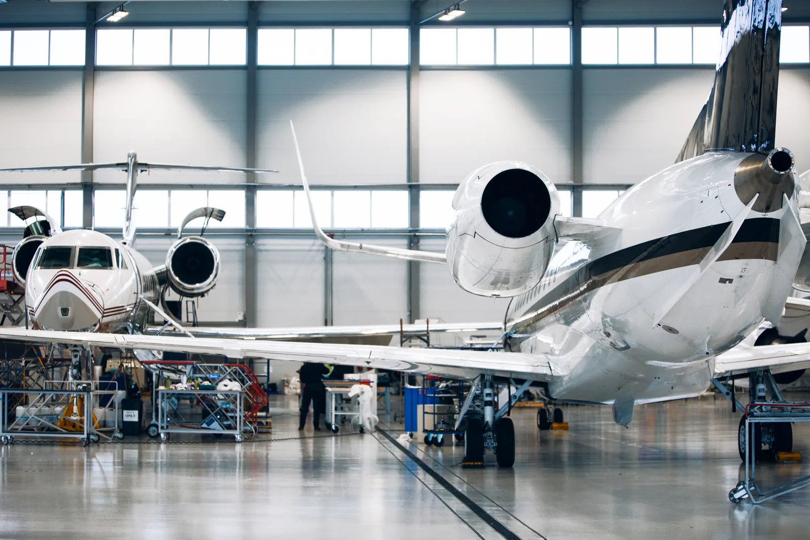 Business jets parked inside a hangar representing an ADS-B-equipped fleet