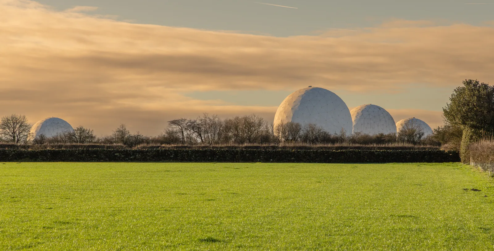 A field of white radar radome domes used for ADS-B and oceanic surveillance