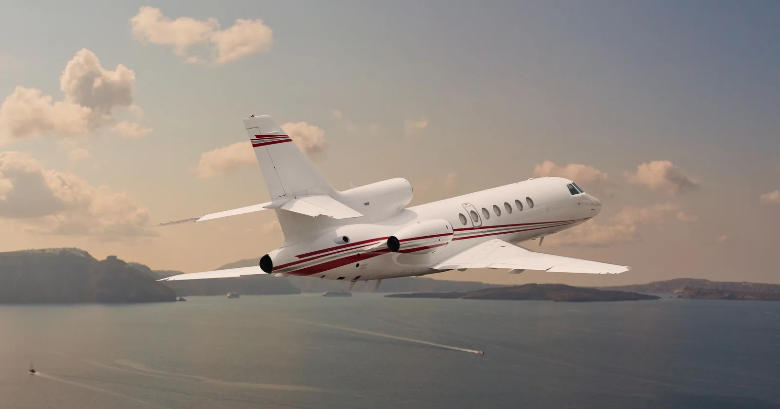 A Dassault Falcon business jet in flight over the sea on an oceanic crossing