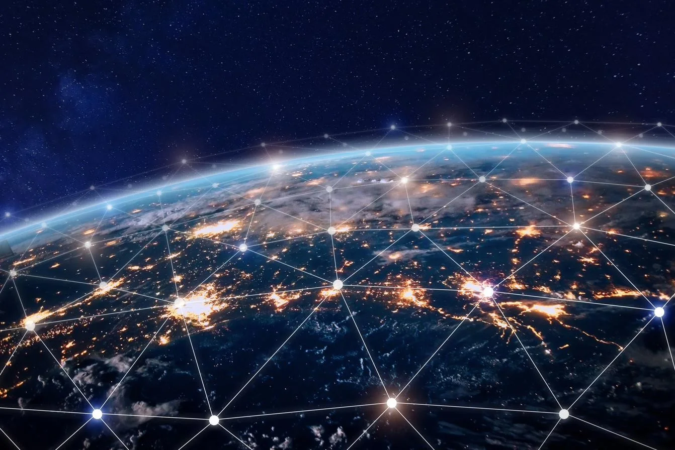 Earth at night overlaid with a global air navigation network of connected nodes