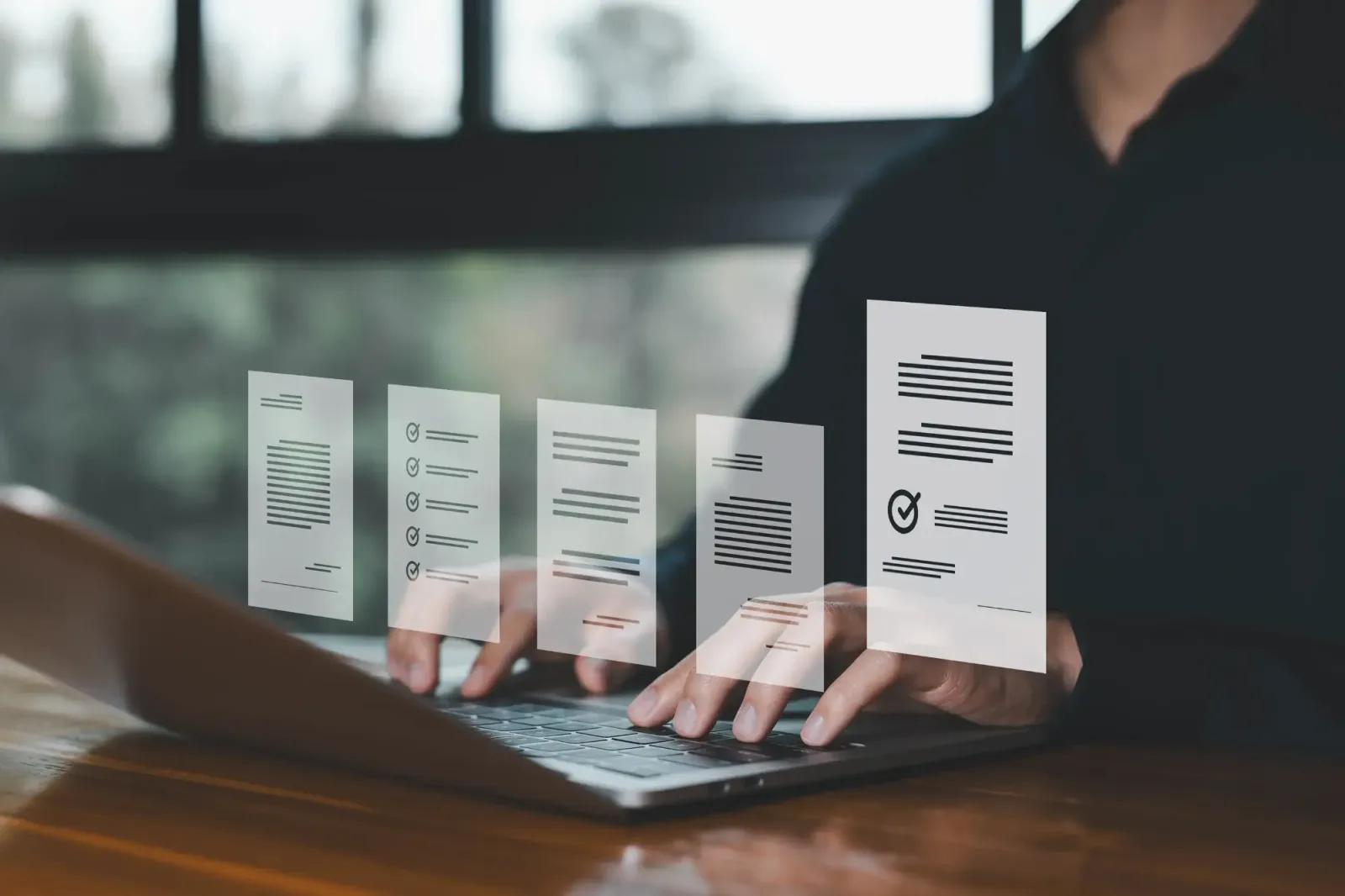 Hands typing on a laptop with digital reference documents and checklists floating above the keyboard