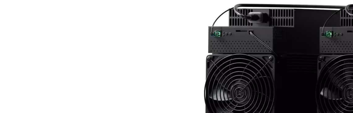 Close-up of the back of a black electronic device with two cooling fans and cables connected.
