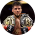Man holding two championship belts over his shoulders, looking forward with a serious expression.