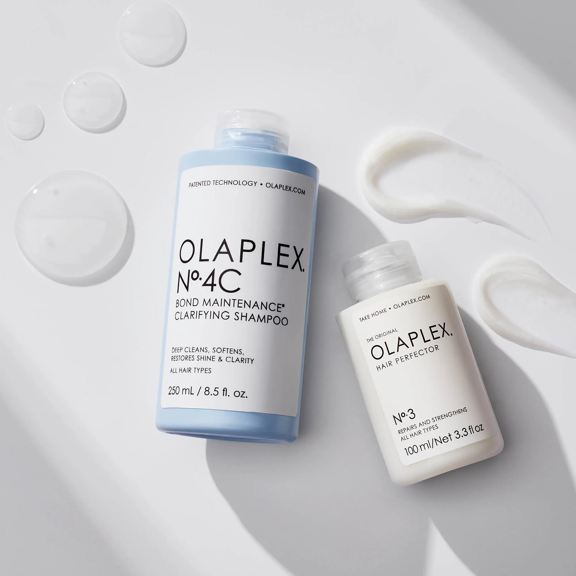 Two Olaplex products: No. 4C clarifying shampoo and No. 3 hair perfector with cream swatches.