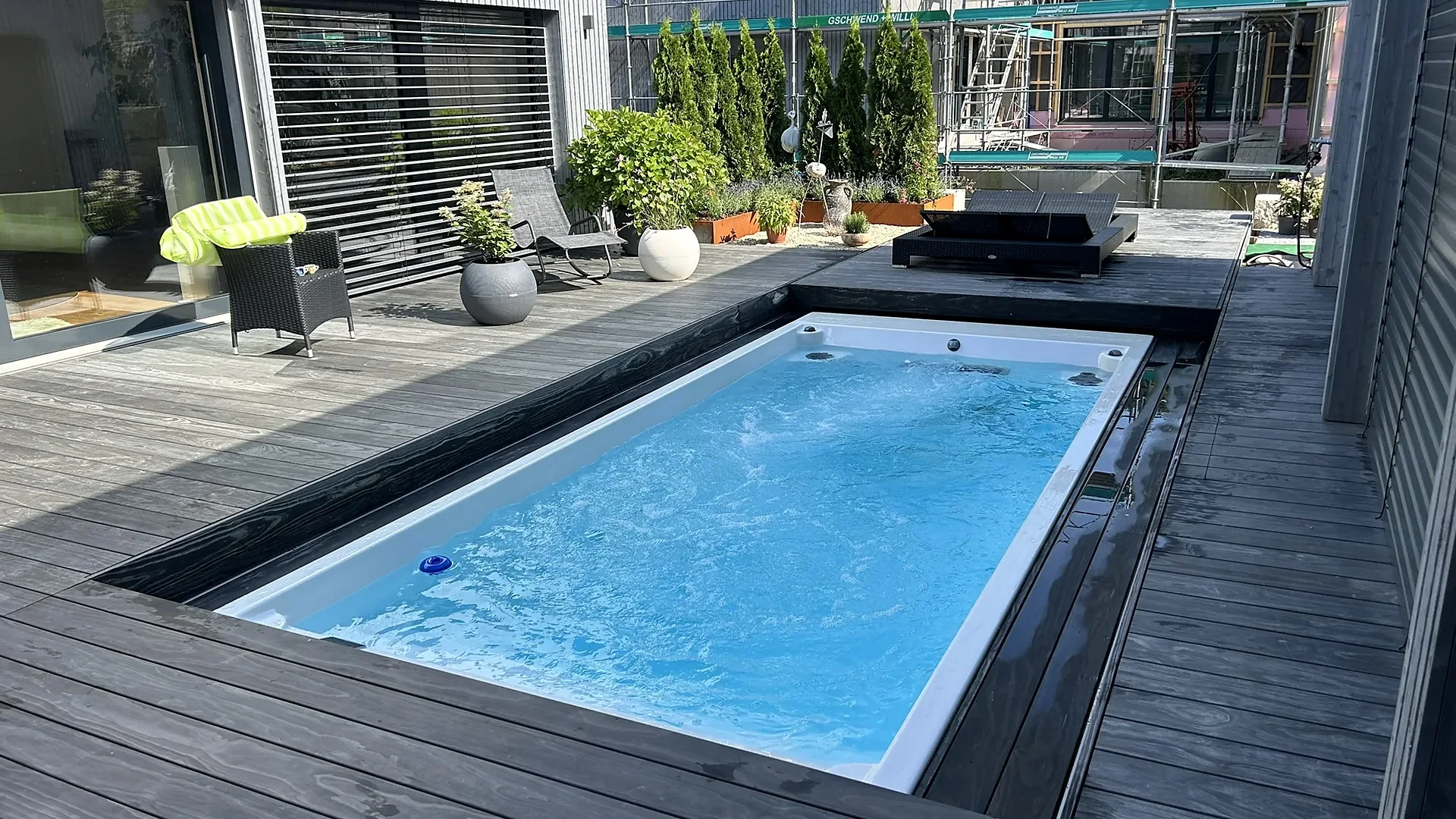 Eingelassener Swim Spa in dunkler Holzterrasse mit Liegen und Pflanzen, Swim Spa von RR Variationen
