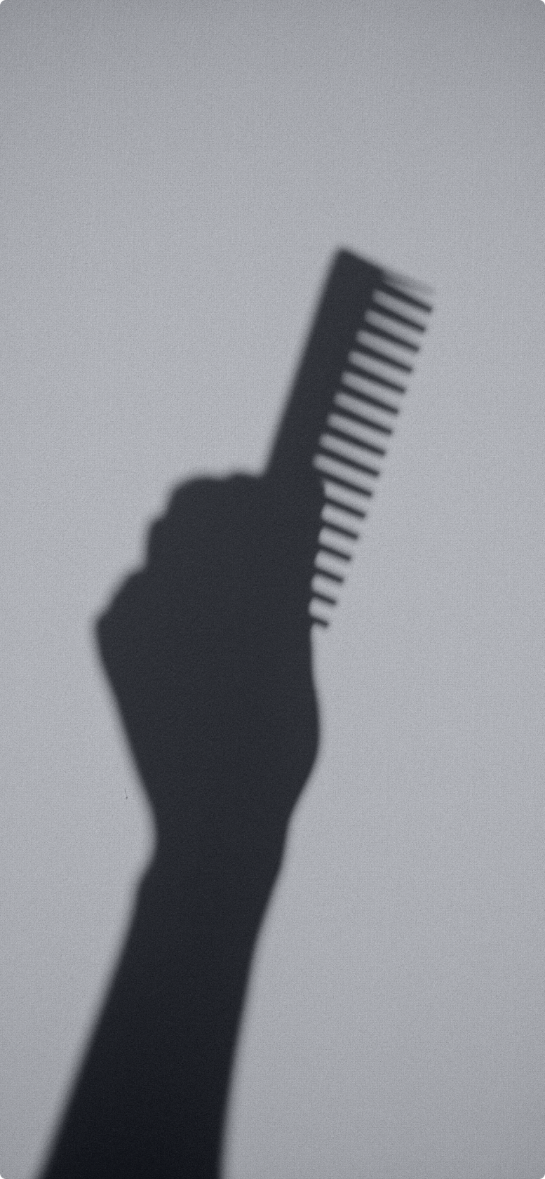 Hand holding a comb representing hair thinning