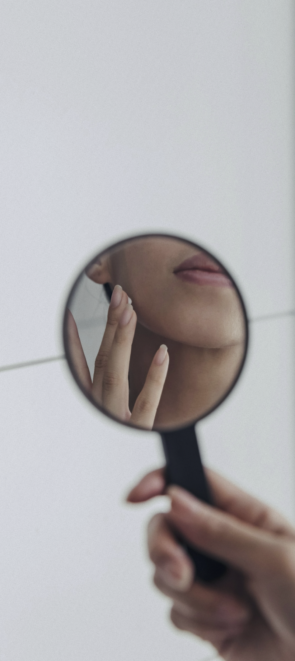 Woman holding a hand mirror