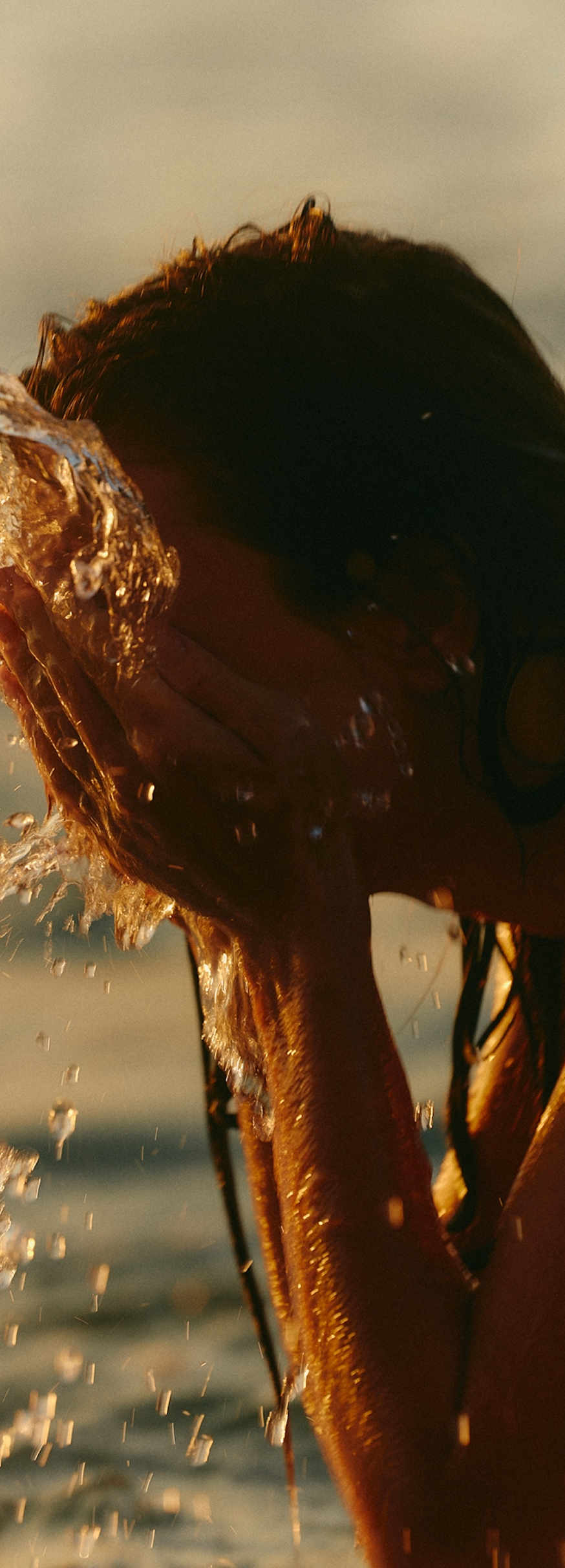 Woman rinsing face with water