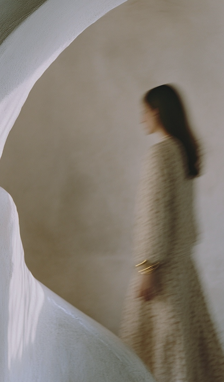 Woman standing thoughtfully in a softly lit room