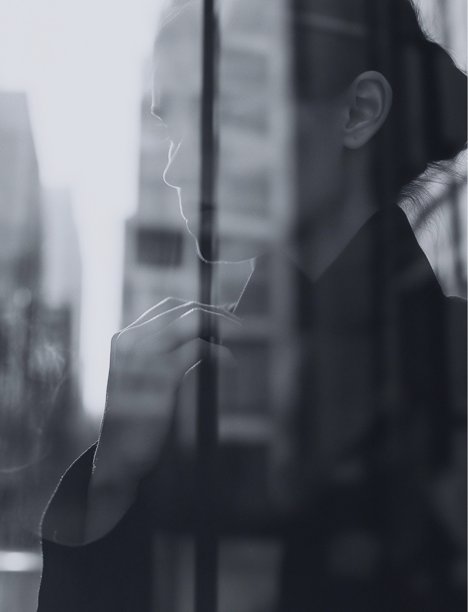 Woman in profile looking out over a city skyline
