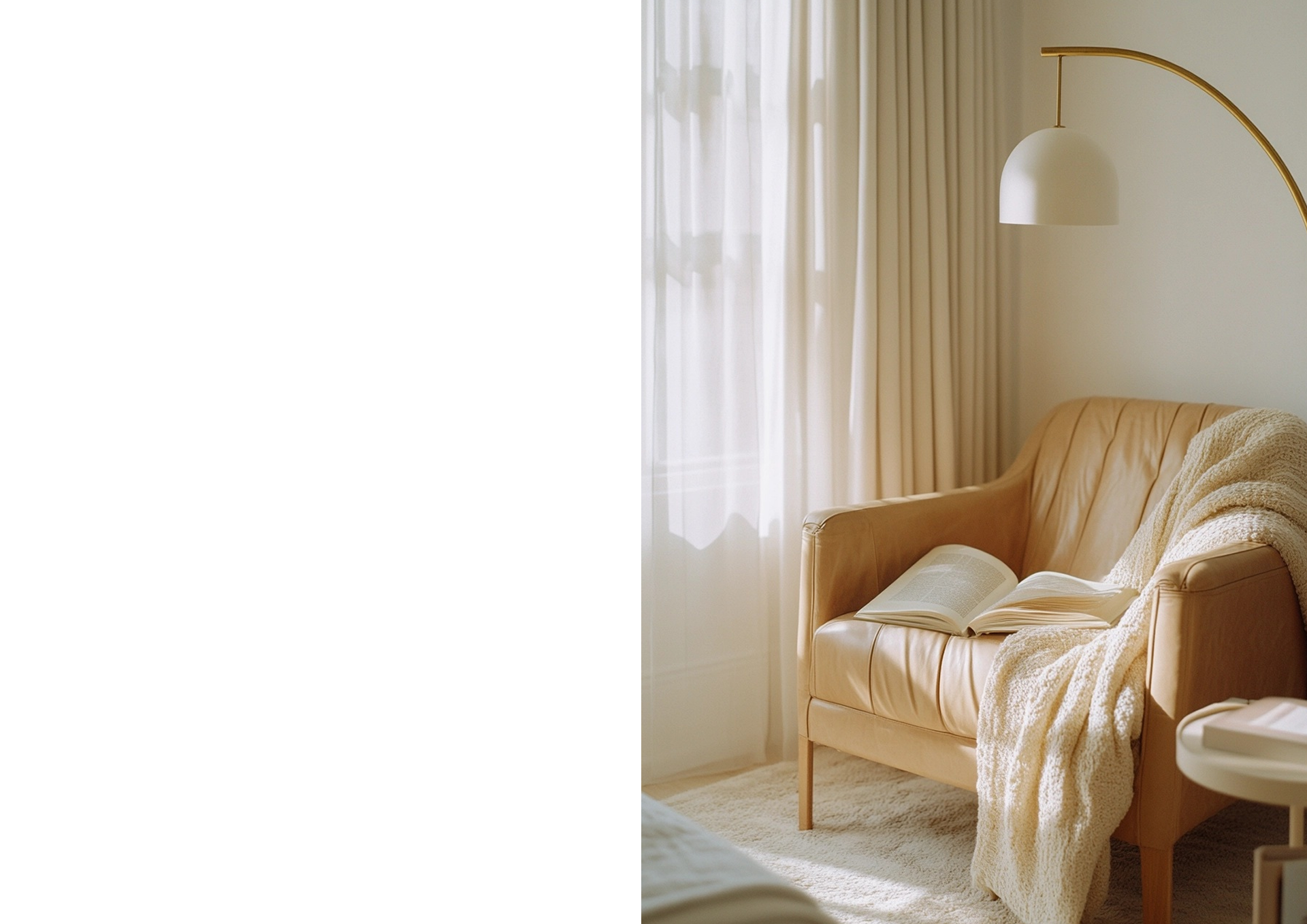A softly lit sitting room with a leather armchair, throw blanket, and open book
