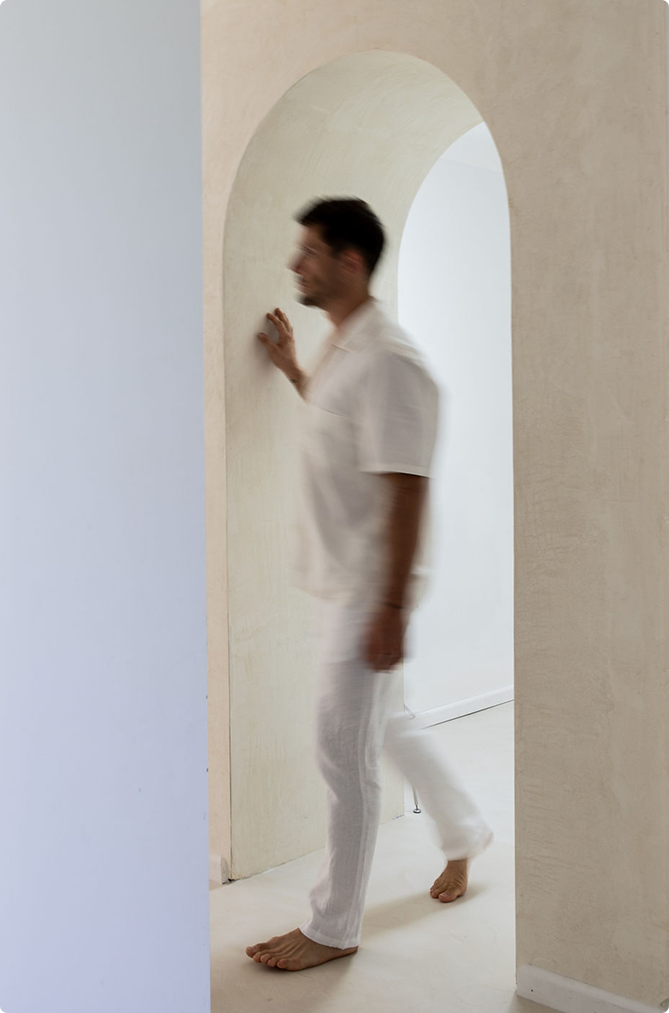 Man in thoughtful pose against an archway