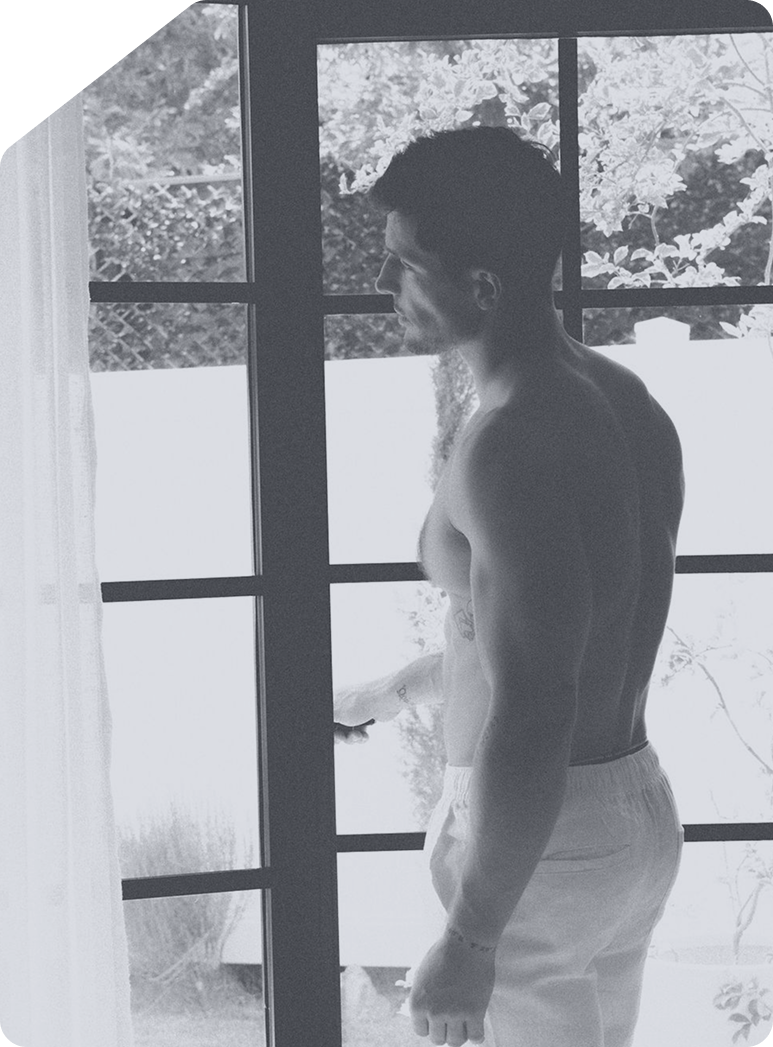 Man looking out through a paned glass door
