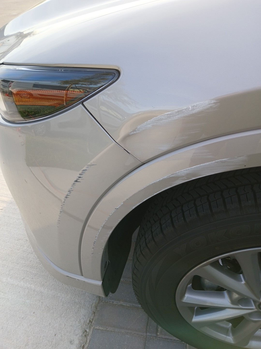 Mazda CX-5 front bumper, driver-side fender and fender flare before mobile repair in San Antonio, Florida.