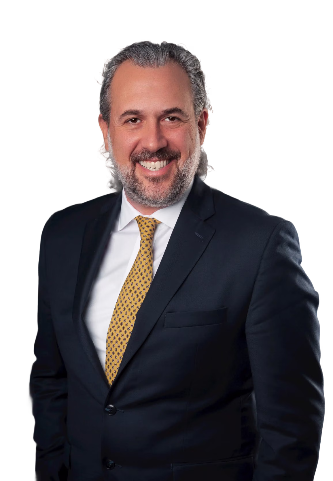 Smiling man with gray hair and beard wearing a dark suit and yellow patterned tie.