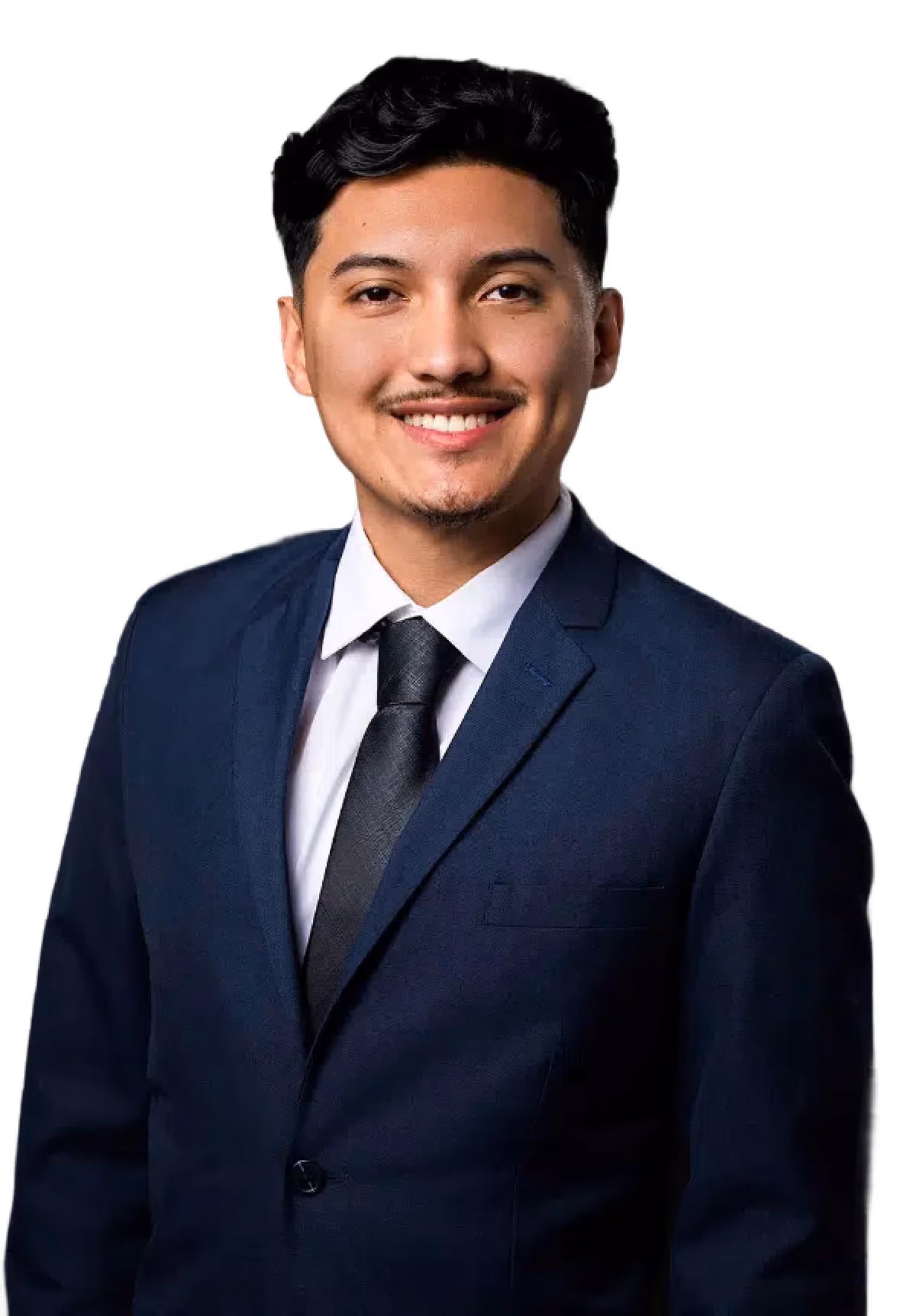 Smiling young man with dark hair wearing a navy blue suit, white shirt, and black tie against a black background.