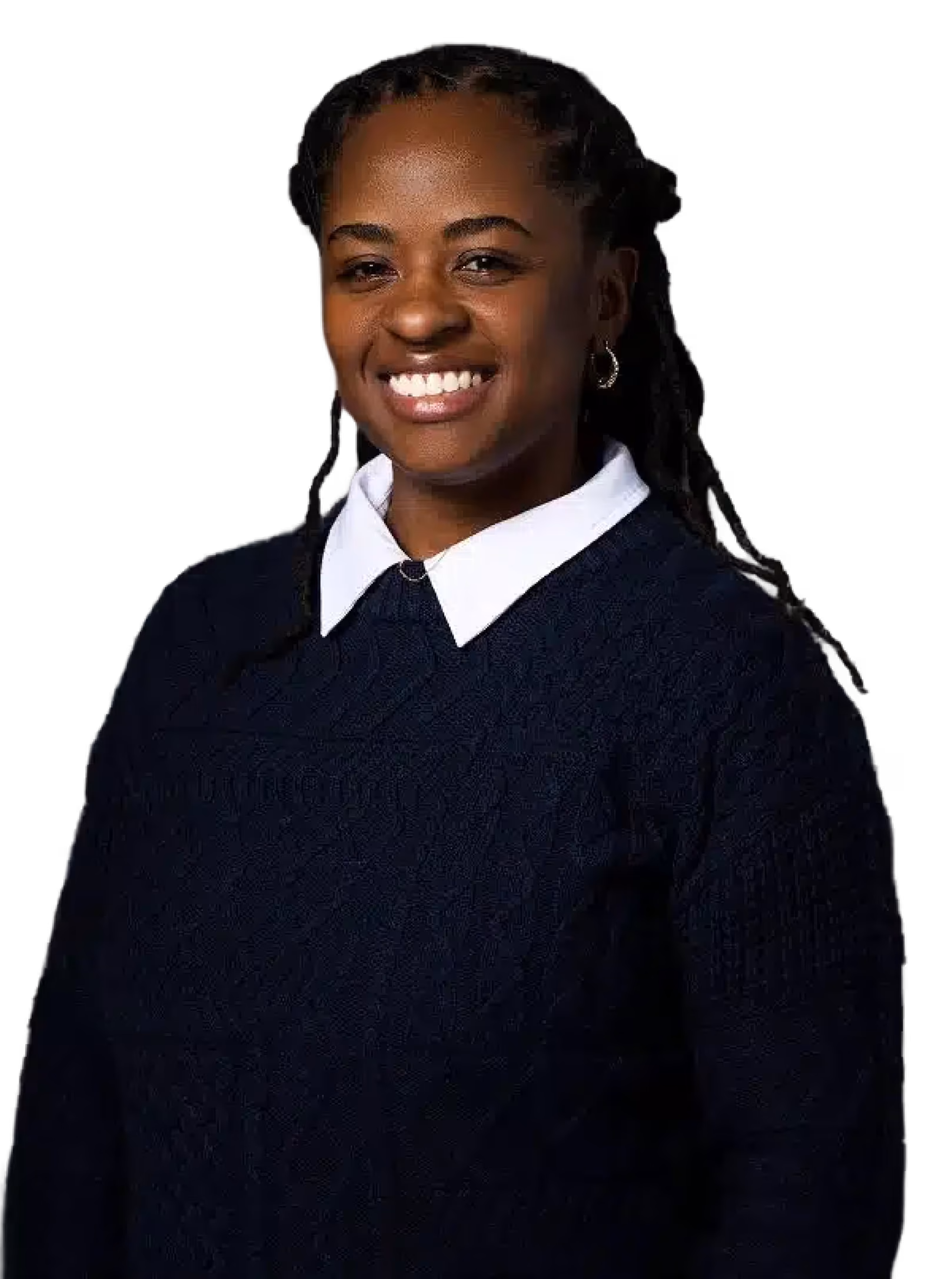 Smiling woman with braided hair wearing a navy blue sweater and white collared shirt against a black background.