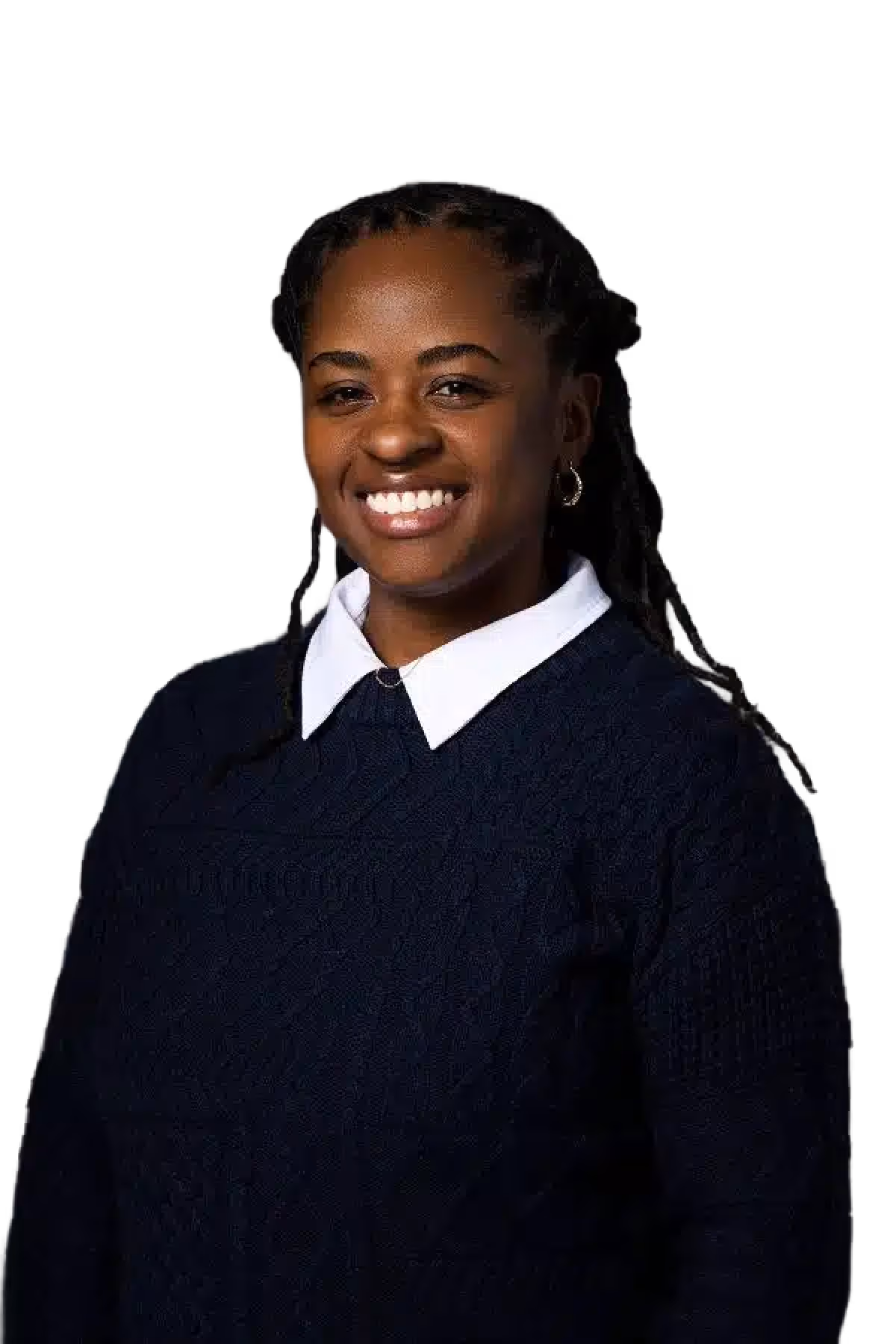 Smiling woman with braided hair wearing a navy blue sweater and white collared shirt against a black background.