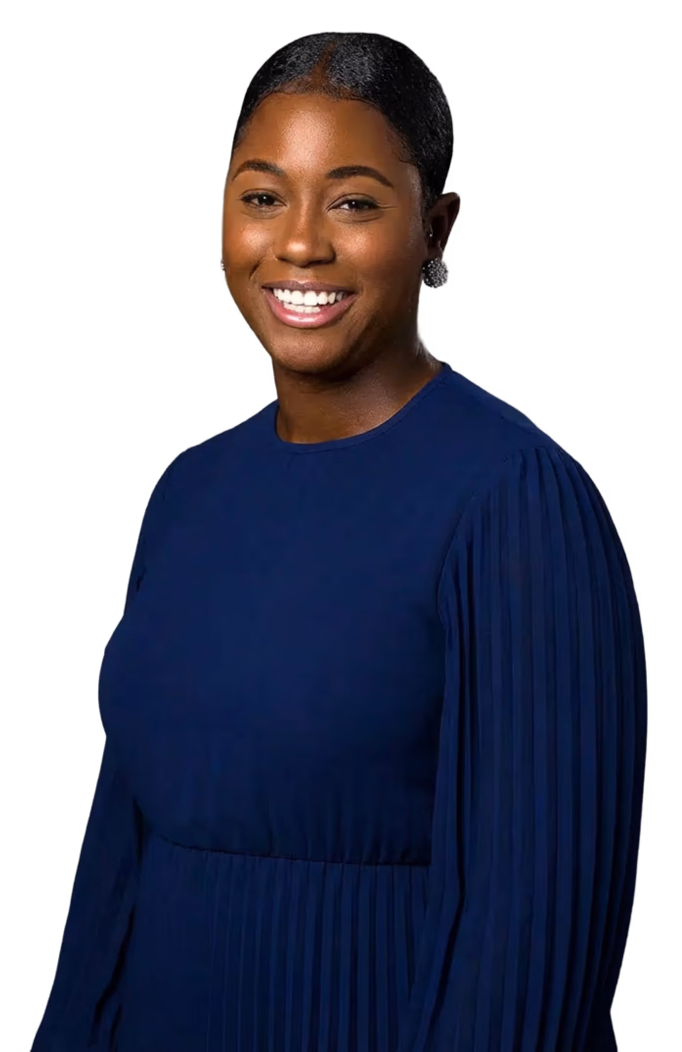 Smiling woman with neatly styled hair wearing a blue pleated dress against a black background.