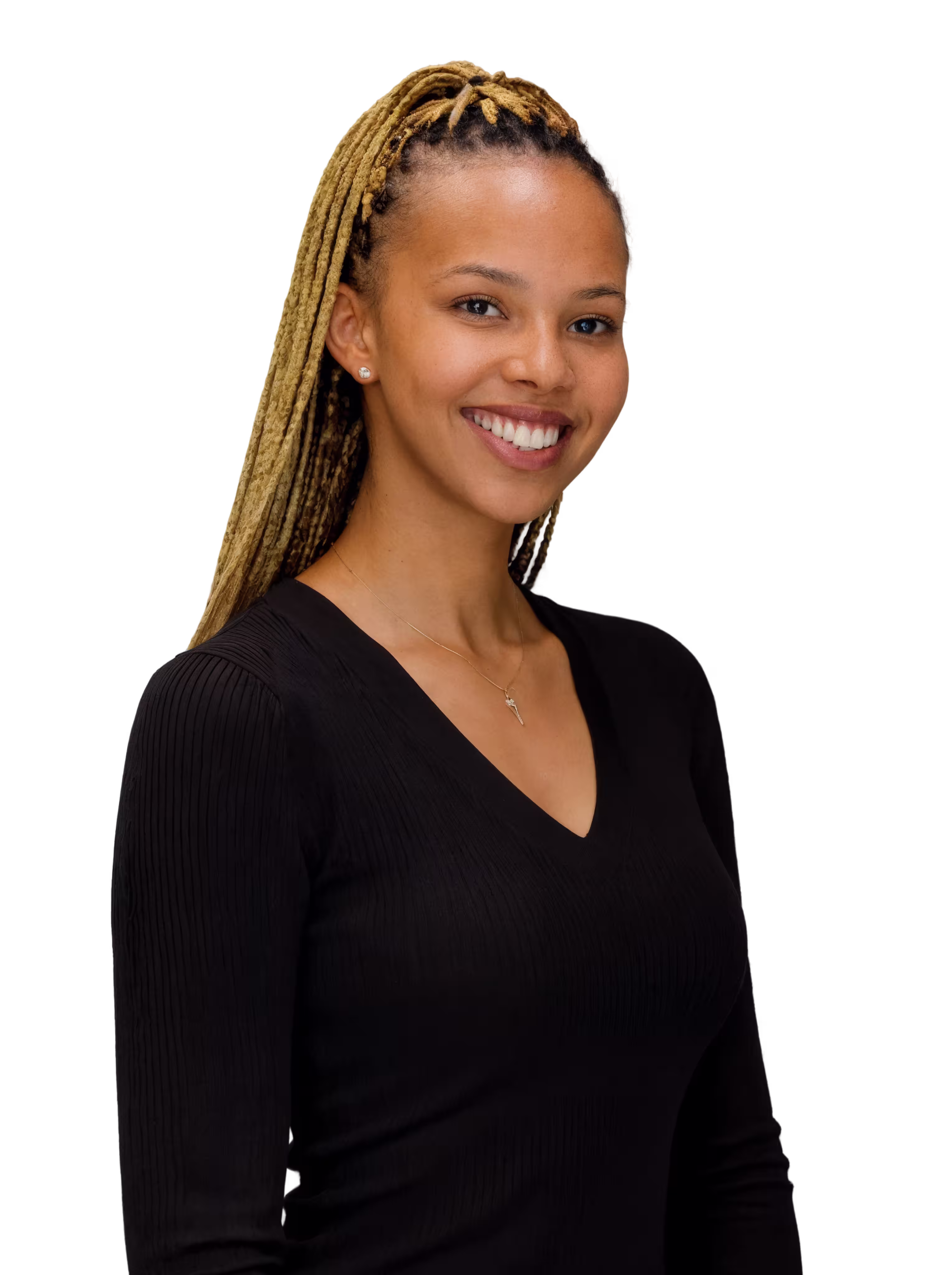 Smiling woman with long blonde dreadlocks wearing a black V-neck top and a necklace with a pendant.
