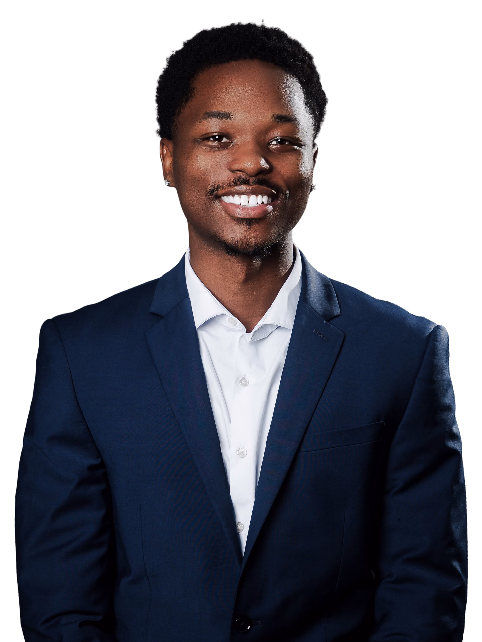 Smiling young man wearing a black suit and light blue tie against a black background.