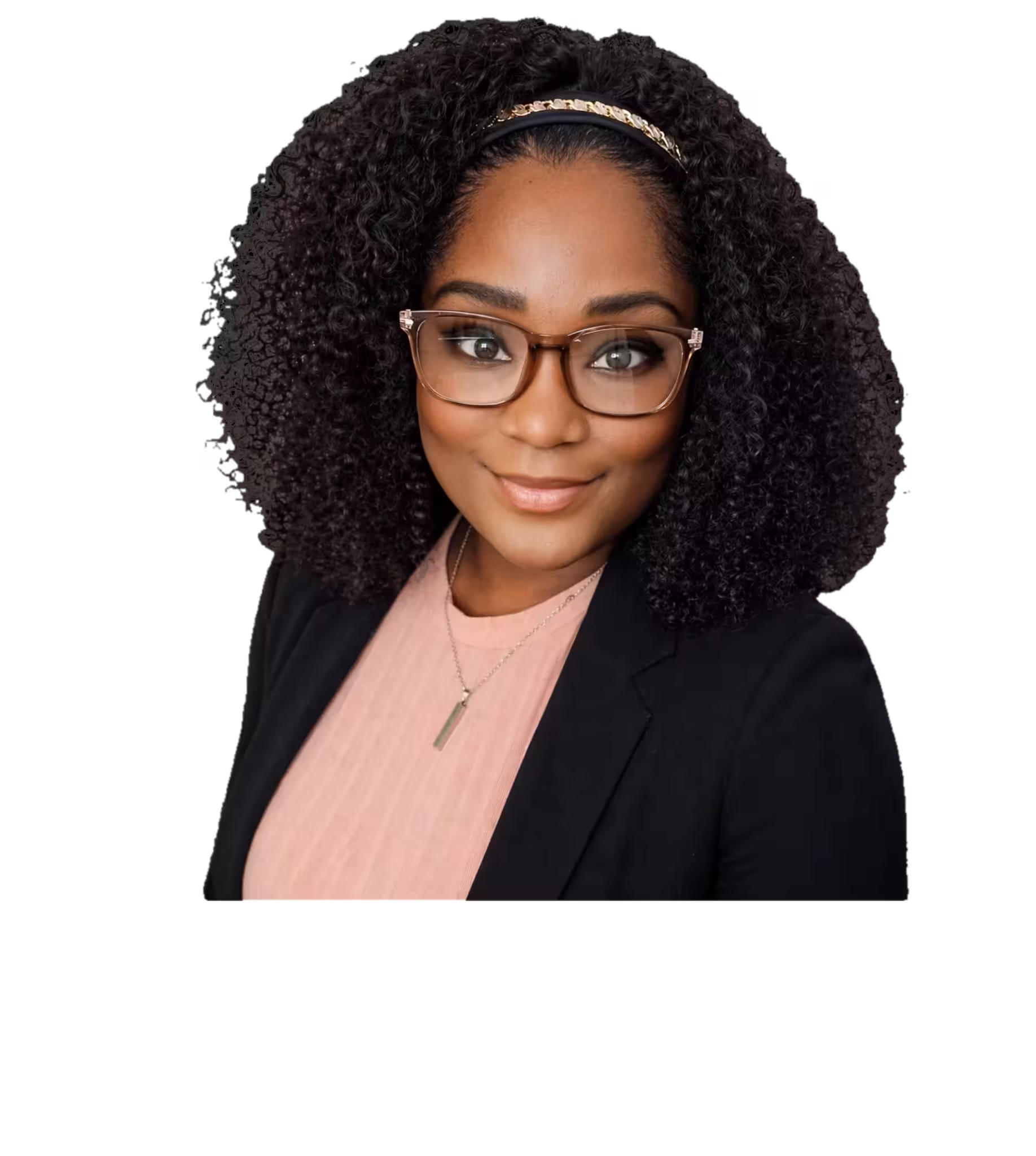 Smiling woman with curly hair, glasses, black blazer, and pink top on black background.