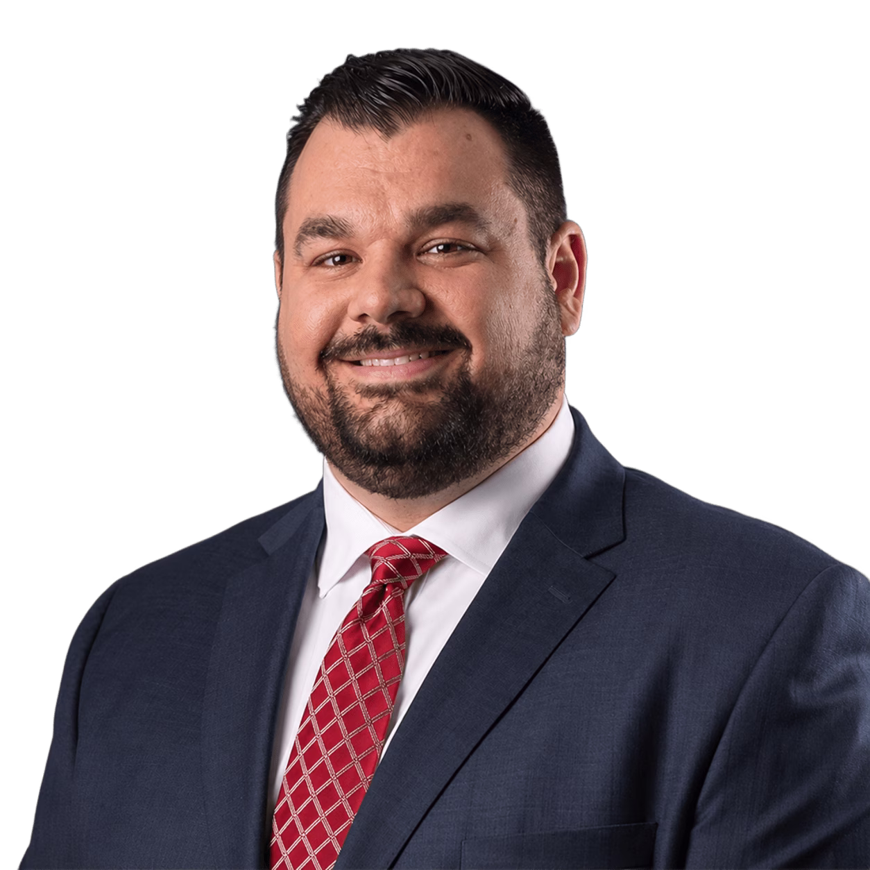 Smiling man with short dark hair and beard wearing navy suit, white shirt, and red patterned tie.