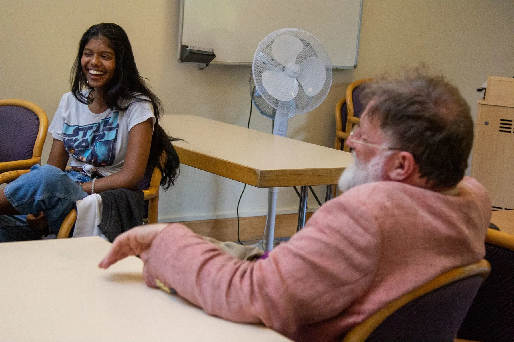 Student and teacher in classroom talking