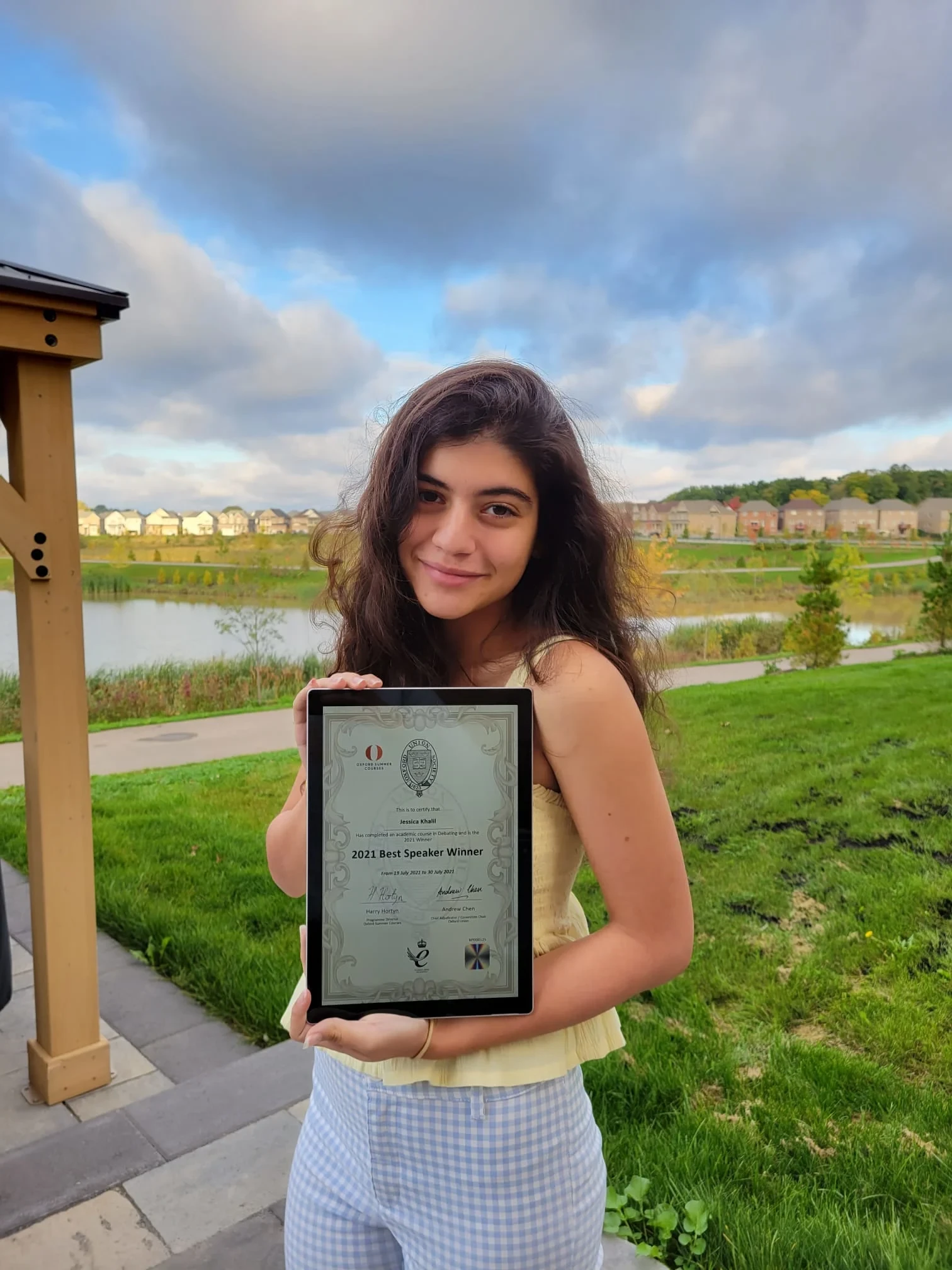 A girl posing with her diploma