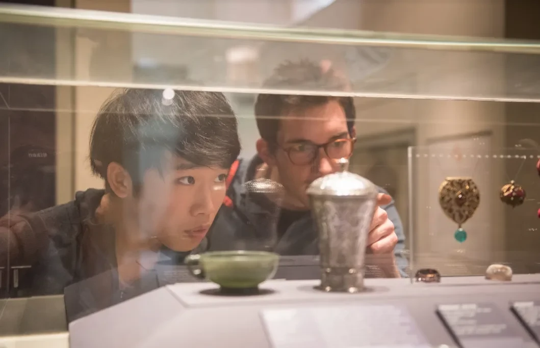 Two students looking at artifacts